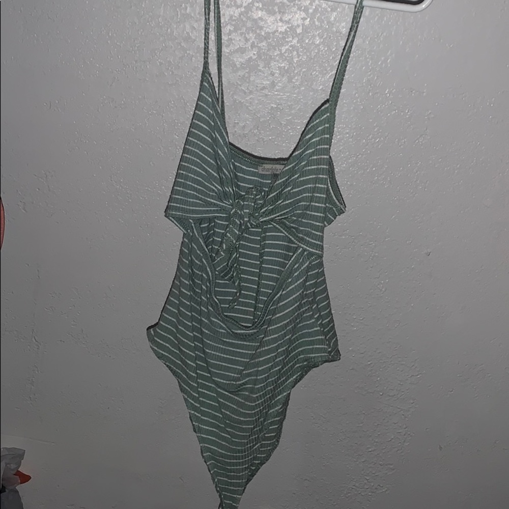 green and white body suit.